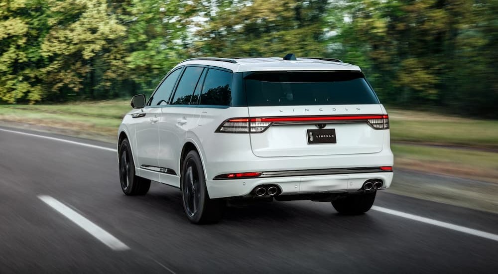 A white 2026 Lincoln Aviator driving on a highway.