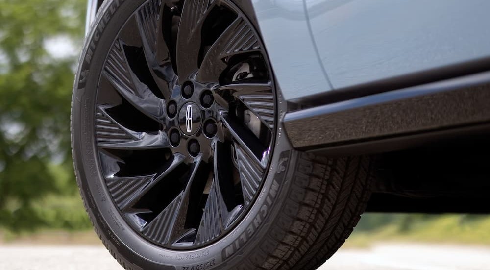 A wheel on a blue 2027 Lincoln Navigator.