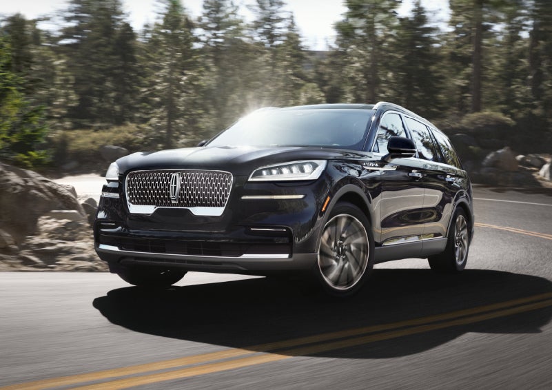 A Lincoln Aviator® SUV is being driven on a winding mountain road | LaFontaine Lincoln Grand Blanc in Flint MI