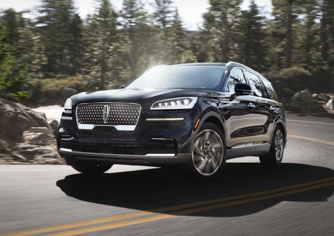 A Lincoln Aviator® SUV is being driven on a winding mountain road | LaFontaine Lincoln Flushing in Flushing MI