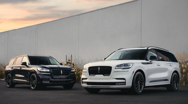 Two Lincoln Aviator® SUVs are shown with the available Jet Appearance Package | LaFontaine Lincoln Flushing in Flushing MI