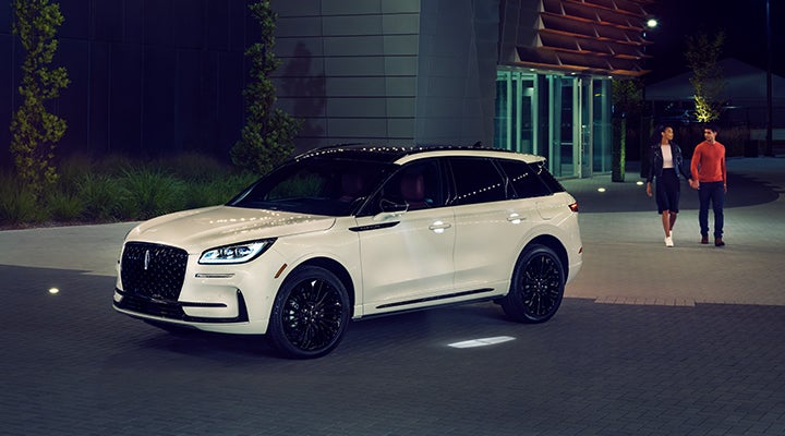 Two people approach a 2024 Lincoln Corsair® SUV featuring the available Jet Appearance Package. | LaFontaine Lincoln Grand Blanc in Flint MI