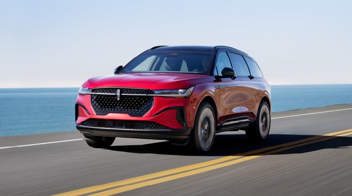 A 2024 Lincoln Nautilus® SUV is being driven on a seaside roadway. | LaFontaine Lincoln Grand Blanc in Flint MI