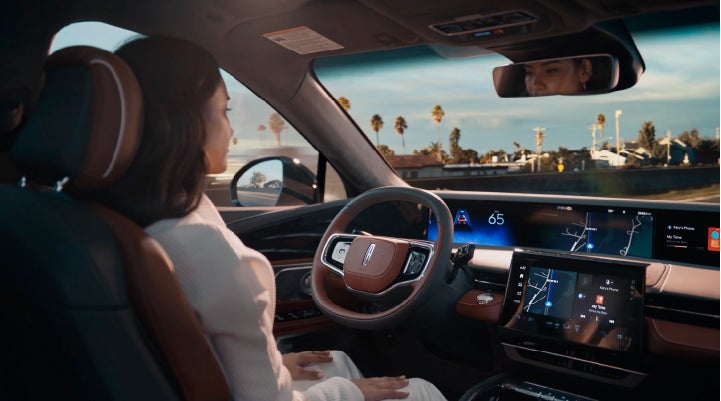 A person is shown driving hands-free on the highway with available Lincoln BlueCruise technology. | LaFontaine Lincoln Flushing in Flushing MI