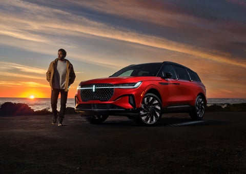A person is shown next to a 2024 Lincoln Nautilus® SUV as the Lincoln Embrace sequence takes place. | LaFontaine Lincoln Flushing in Flushing MI