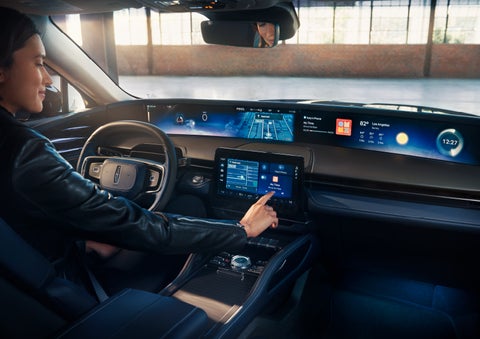 The driver of a 2024 Lincoln Nautilus® SUV interacts with the center touchscreen. | LaFontaine Lincoln Flushing in Flushing MI