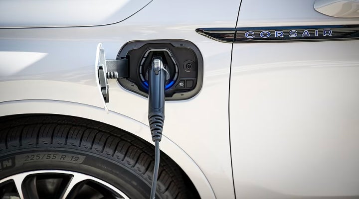 An electric charger is shown plugged into the charging port of a Lincoln Corsair® Grand Touring
model. | LaFontaine Lincoln Flushing in Flushing MI