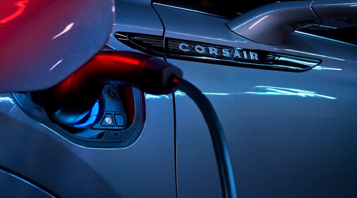 A charger plugged into the charging port of a 2024 Lincoln Corsair® Plug-in Hybrid model. | LaFontaine Lincoln Flushing in Flushing MI