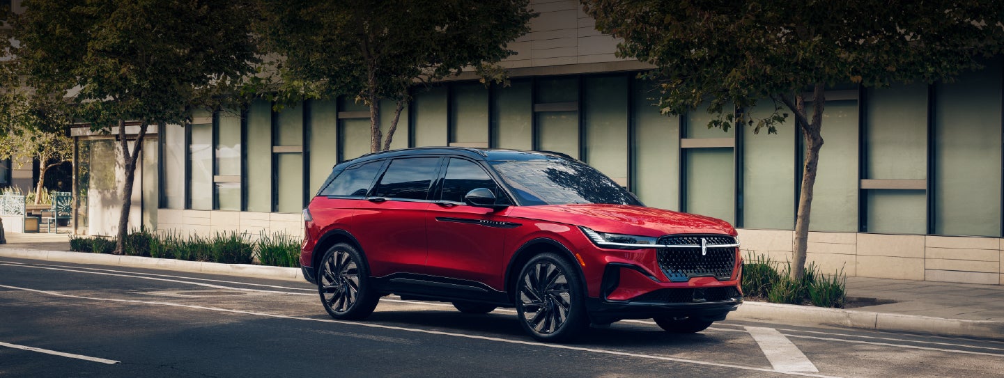 A 2025 Lincoln Nautilus® SUV with an available hybrid powertrain is parked in an urban setting. | LaFontaine Lincoln Grand Blanc in Flint MI