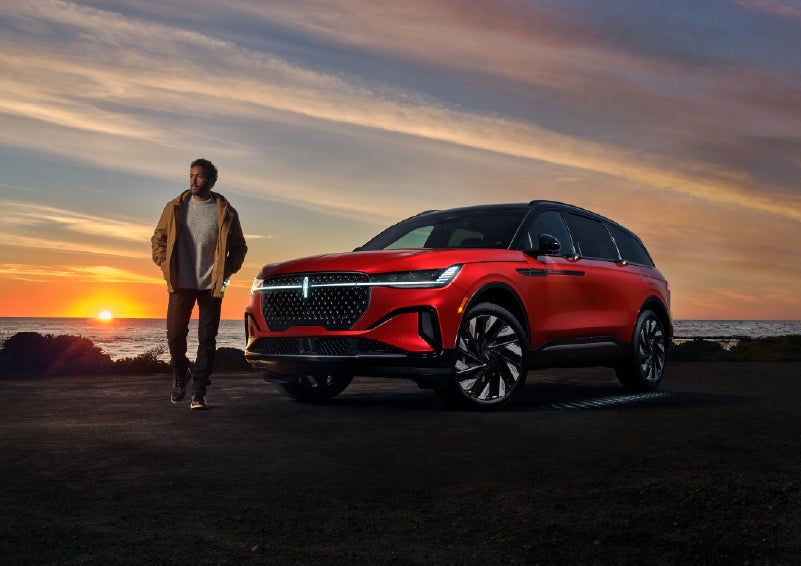 A person is shown next to a 2025 Lincoln Nautilus® SUV as the Lincoln Embrace sequence takes place. | LaFontaine Lincoln Grand Blanc in Flint MI
