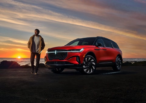 A person is shown next to a 2025 Lincoln Nautilus® SUV as the Lincoln Embrace sequence takes place. | LaFontaine Lincoln Grand Blanc in Flint MI
