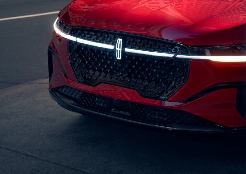 The available front LED light bar and center Lincoln Star logo glow at dusk. | LaFontaine Lincoln Grand Blanc in Flint MI