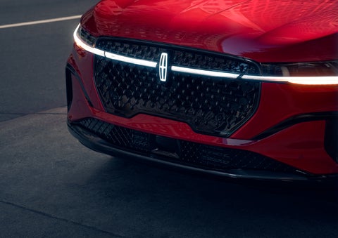 The available front LED light bar and center Lincoln Star logo glow at dusk. | LaFontaine Lincoln Grand Blanc in Flint MI