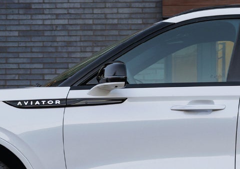 The driver’s side door and fender badging of a white 2026 Lincoln Aviator® SUV are showcased. | LaFontaine Lincoln Grand Blanc in Flint MI