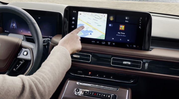 A person is tapping the center display touchscreen of a 2026 Lincoln Aviator® SUV. | LaFontaine Lincoln Grand Blanc in Flint MI