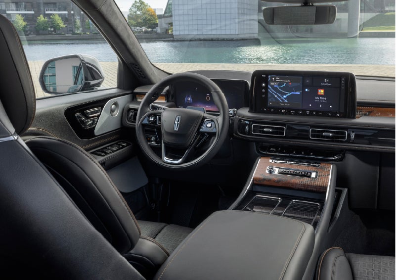 The interior of the 2026 Lincoln Aviator® SUV is shown parked with a view of a harbor through the windshield. | LaFontaine Lincoln Grand Blanc in Flint MI
