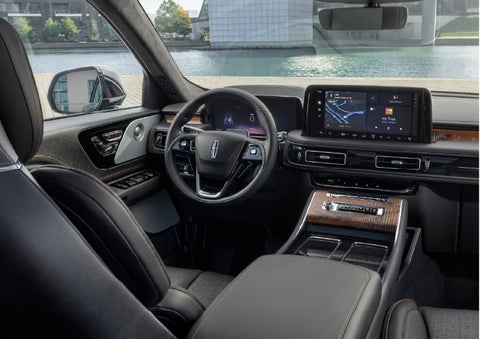 The interior of the 2026 Lincoln Aviator® SUV is shown parked with a view of a harbor through the windshield. | LaFontaine Lincoln Grand Blanc in Flint MI