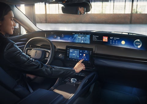 The driver of a 2026 Lincoln Nautilus® SUV interacts with the center touchscreen. | LaFontaine Lincoln Grand Blanc in Flint MI