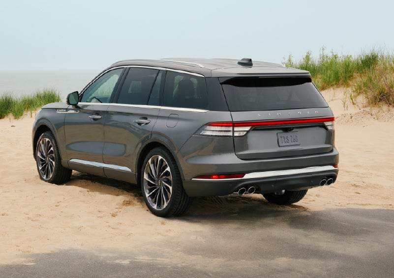 A 2027 Lincoln Aviator® SUV is parked next to sand dunes. | LaFontaine Lincoln Grand Blanc in Flint MI