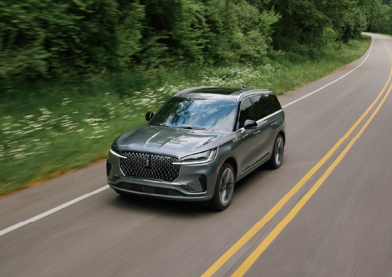 A 2027 Lincoln Aviator® SUV is being driven down a road. | LaFontaine Lincoln Grand Blanc in Flint MI
