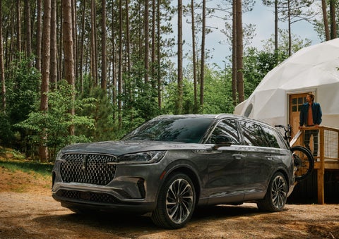 A 2027 Lincoln Aviator® is parked next to a high end glamping site. | LaFontaine Lincoln Grand Blanc in Flint MI