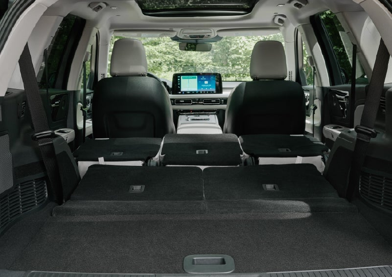 A rear to front view of the interior of a 2027 Lincoln Aviator® Black Label™ SUV shows the third and second rows folded flat | LaFontaine Lincoln Grand Blanc in Flint MI
