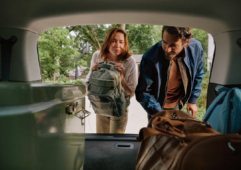 A couple loads luggage into the rear of a 2027 Lincoln Aviator® Black Label™ SUV..e 202 | LaFontaine Lincoln Grand Blanc in Flint MI