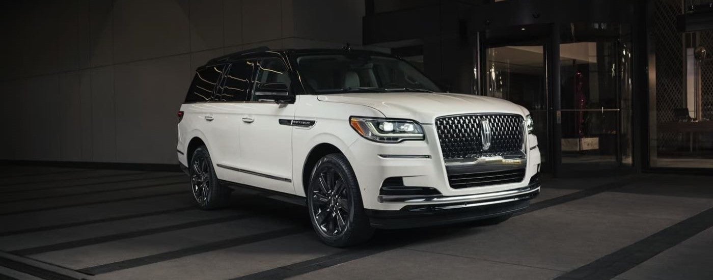 A white 2023 Lincoln Navigator parked at night