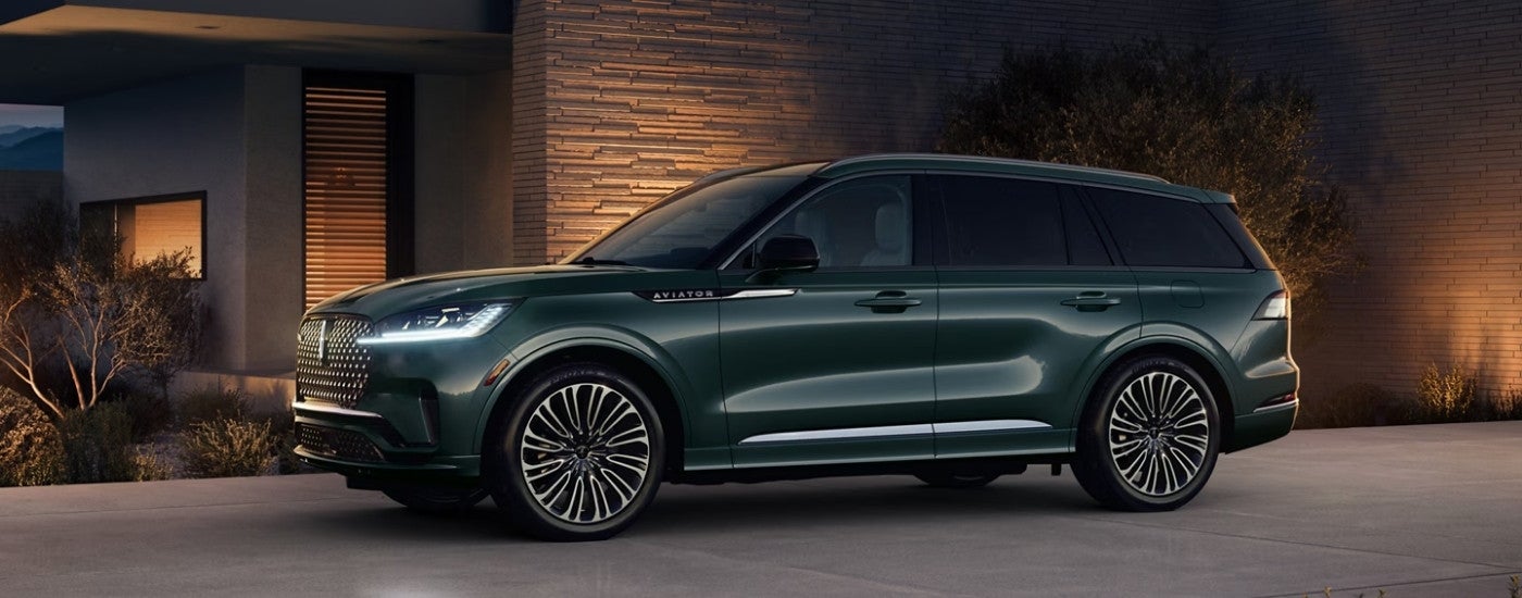 A green 2025 Lincoln Aviator from the side after leaving a Lincoln dealer.