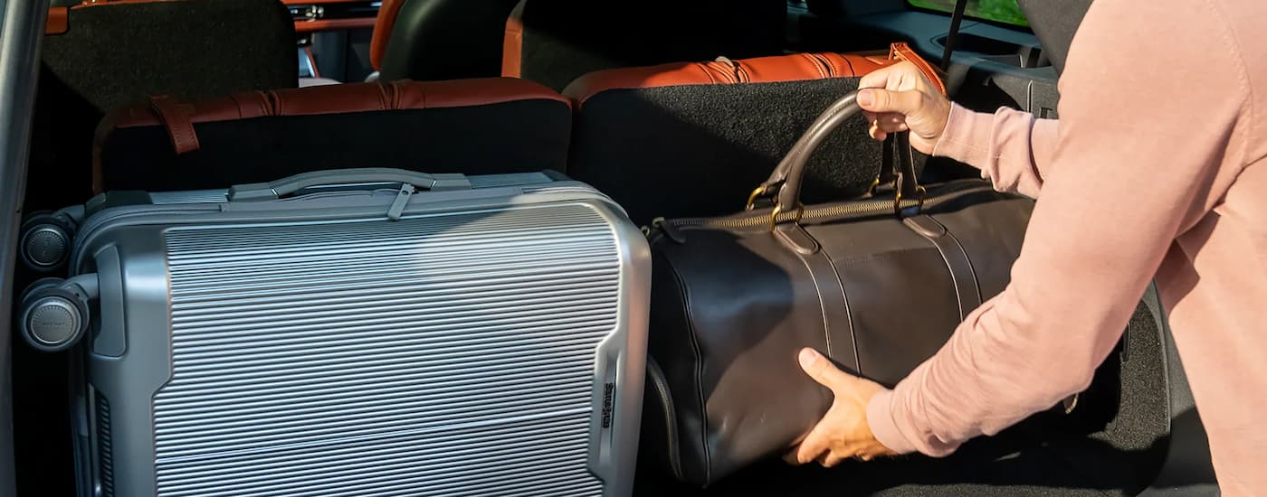 Person putting bags into the back of a 2025 Lincoln Aviator