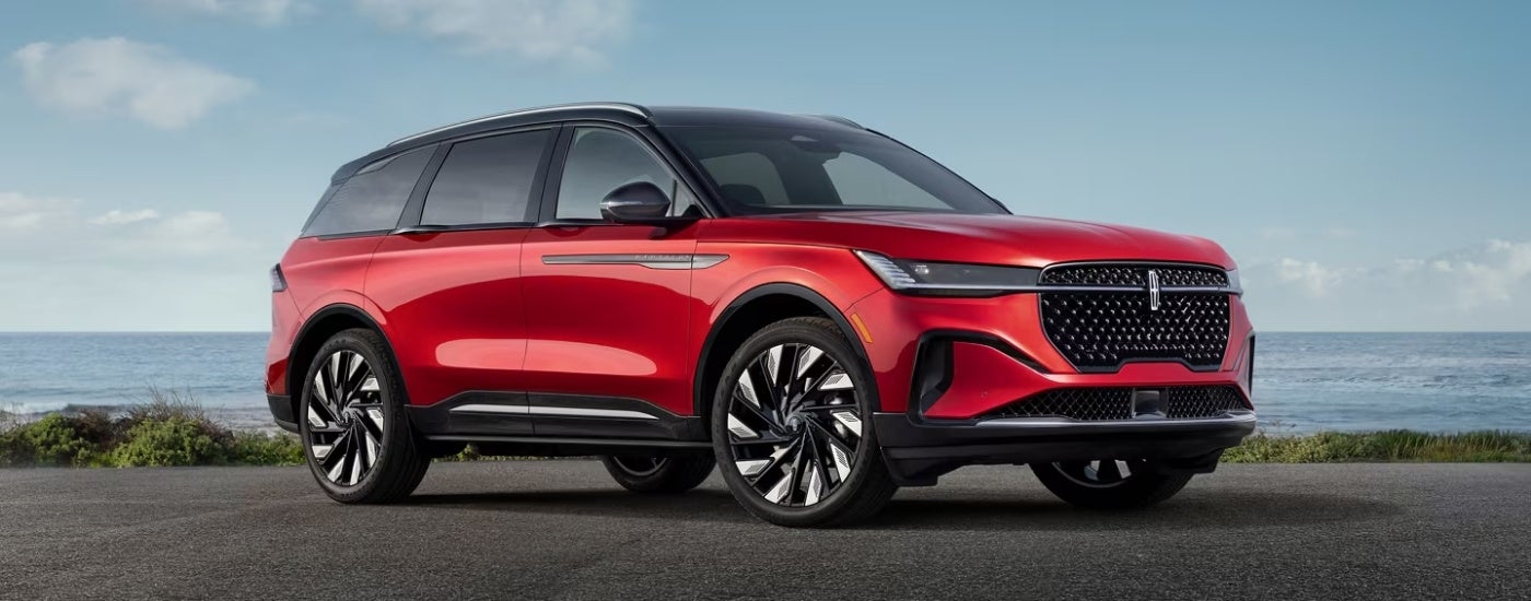 A red 2025 Lincoln Nautilus from the side.