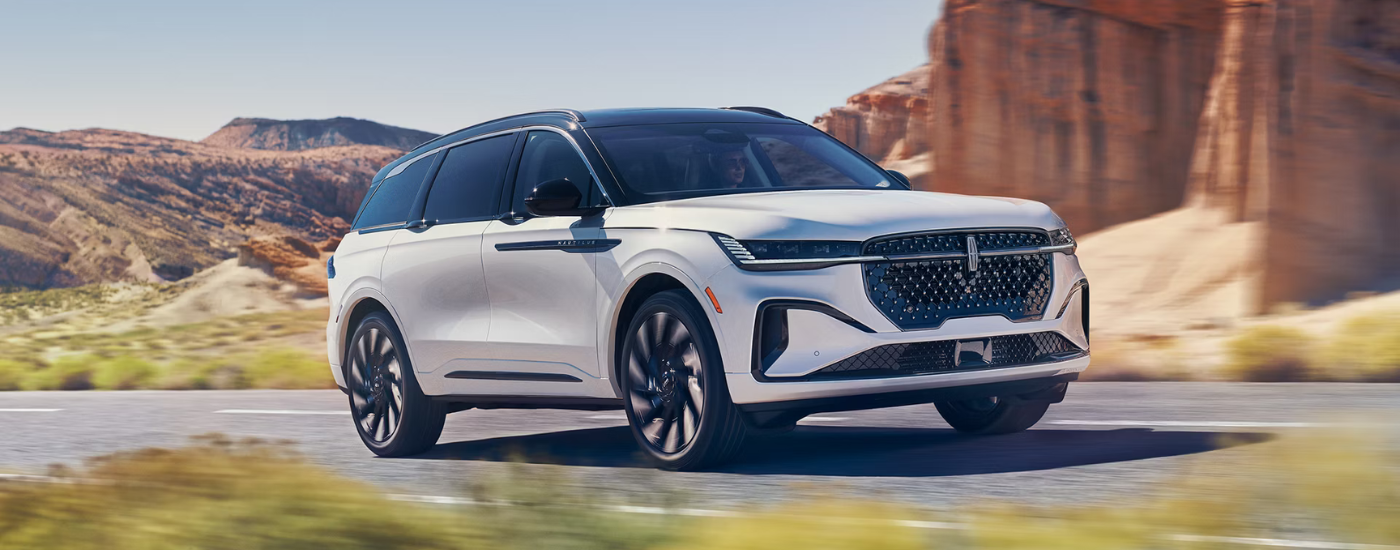 White 2026 Lincoln Nautilus driving on a canyon road