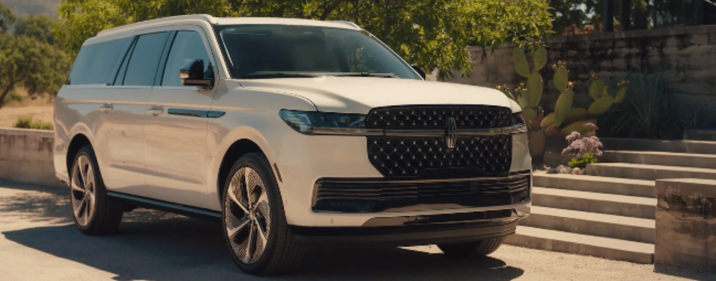White 2027 Lincoln Navigator parked outside of a house