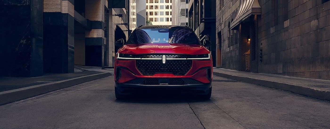 A red 2026 Lincoln Nautilus driving in a city.