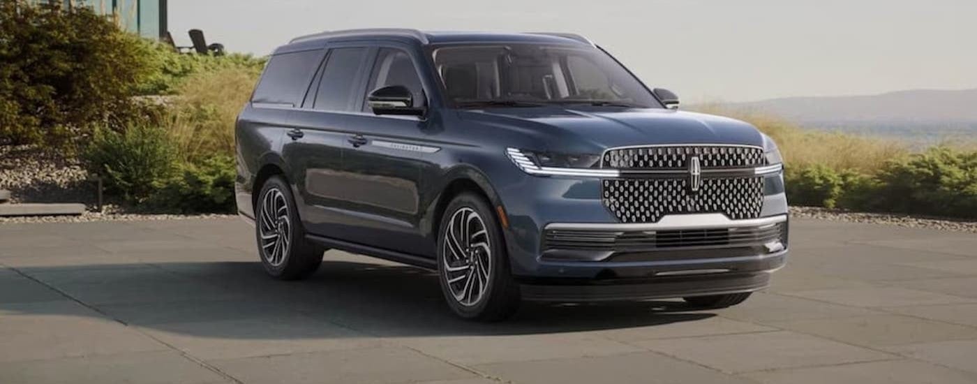 A blue 2024 Lincoln Navigator parked on a driveway.