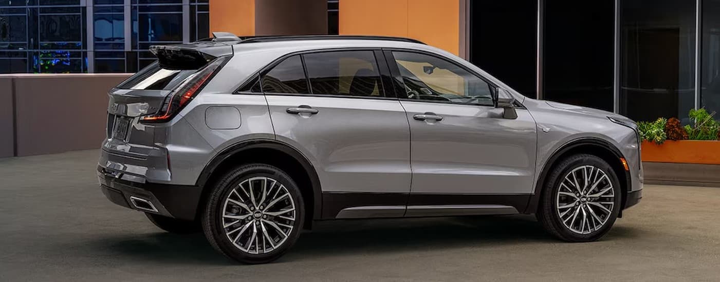 A white 2024 Cadillac XT4 parked near a building.